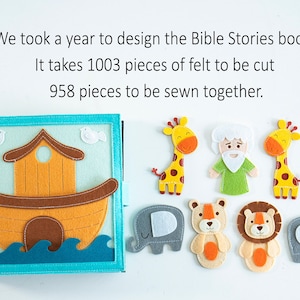 May include: A felt book with a blue cover and a picture of a brown ark on the front. The book is open to reveal a felt scene with a blue background, a brown ark, and two white birds. There are also felt figures of a giraffe, a man with a beard, a lion, an elephant, and a bear.