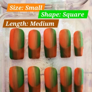 May include: A set of square-shaped, medium-length false nails in a clear plastic case. The nails are small in size and feature a gradient design, transitioning from orange to green. The text "Size: Small", "Shape: Square", and "Length: Medium" are visible.