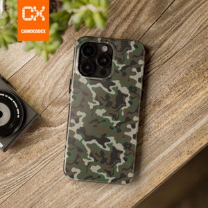 May include: A smartphone case featuring a camouflage pattern in shades of dark green, olive, brown, and black. The case has a rectangular cutout at the top left corner for the camera lenses and is designed to fit a modern smartphone device.