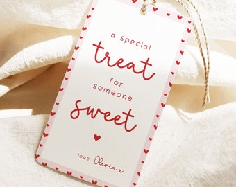 May include: A pink gift tag with a red heart border. The tag says "a special treat for someone sweet. love, Olivia x".