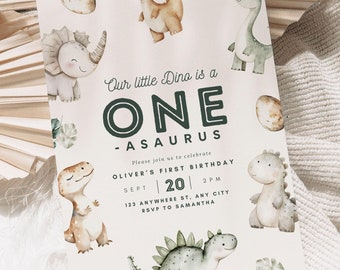 May include: A light pink invitation with green and brown dinosaur illustrations. The text reads "Our little Dino is a ONE -ASAURUS. Please join us to celebrate OLIVER'S FIRST BIRTHDAY SEPT 20 2PM 123 ANYWHERE ST. ANT CITY RSVP TO SAMANTHA".