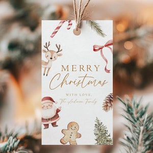 以下が含まれることがあります： ゴールドの「メリークリスマス」のメッセージと「愛を込めて、アンダーソン家」のテキストが書かれた白いギフトタグ。タグは、トナカイ、サンタクロース、ジンジャーブレッドマン、キャンディーケーン、松の木、松ぼっくりなどの水彩画で飾られています。