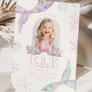 May include: A rectangular birthday invitation card featuring a central arched photo frame, watercolor illustrations of mermaid tails, seashells, and coral in pastel shades of pink, purple, and teal, with the text IT'S TIME FOUR A SHELLABRATION.
