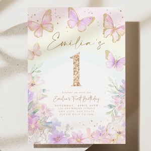 May include: A pastel-colored invitation card with butterflies and floral accents. The card features the name "Emilia's" and the number "1" in gold glitter. Text reads "Emilia's First Birthday" with event details.
