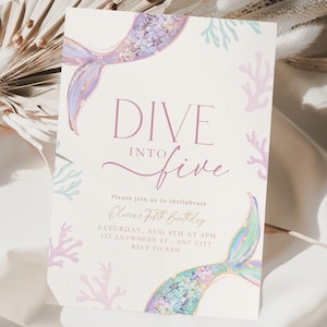 May include: A rectangular birthday invitation card featuring a cream background with illustrations of two iridescent mermaid tails and pastel coral branches. The text reads: DIVE INTO five, Please join us to shellabrate, Olivia's Fifth Birthday, SATURDAY, AUG 4TH AT 4PM, 123 ANYWHERE ST - ANY CITY, RSVP TO SAM.