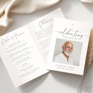May include: A folded memorial card with the text "Order of Service" and "Obituary". The card features a photo of a man and the words "celebrating the life of Andrew James". The design is minimalist with a cream colour.