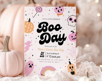 May include: A Halloween-themed invitation with the words "Boo Day" in a retro font. The invitation features illustrations of pumpkins, ghosts, and a rainbow. The background is a soft pink, and the invitation is surrounded by pink pumpkins and fabric.