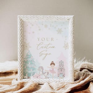 May include: A white framed sign with the text "YOUR Custom Sign" in gold script. The sign features illustrations of a Christmas tree, a ballerina, a toy horse, and a nutcracker. The frame has a textured, diamond pattern.