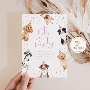 May include: A birthday party invitation featuring watercolor illustrations of various dog breeds wearing party hats. The invitation reads "Let's Pawty!" in pink script, with event details below. A hand holds the invitation.