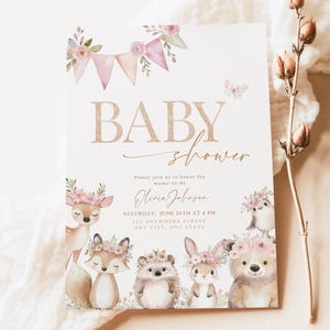 May include: Baby shower invitation featuring woodland animal illustrations and floral decorations. The invitation includes the text "BABY shower" and event details. The design features a deer, fox, hedgehog, bunny, and bear.
