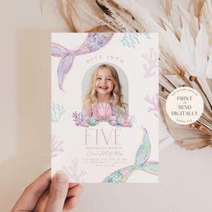 May include: A printable invitation for a 5th birthday party with a mermaid theme. The invitation features a watercolor illustration of a mermaid tail, seashells, and coral. The text "Dive into Five" is written in pink and white. The invitation is designed to be printed or sent digitally.