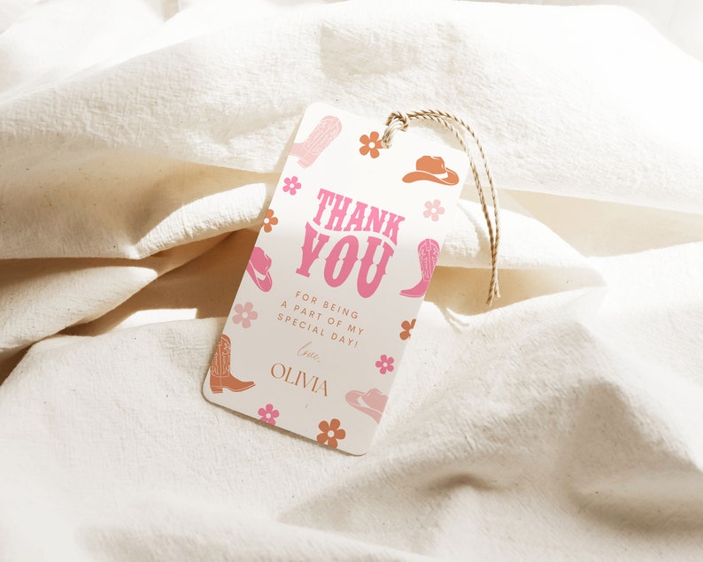 May include: A white thank you tag with pink and orange cowboy boot and hat illustrations. The text reads "Thank You" in pink letters with a pink and orange floral pattern. The text below reads "For being a part of my special day! Love, Olivia."