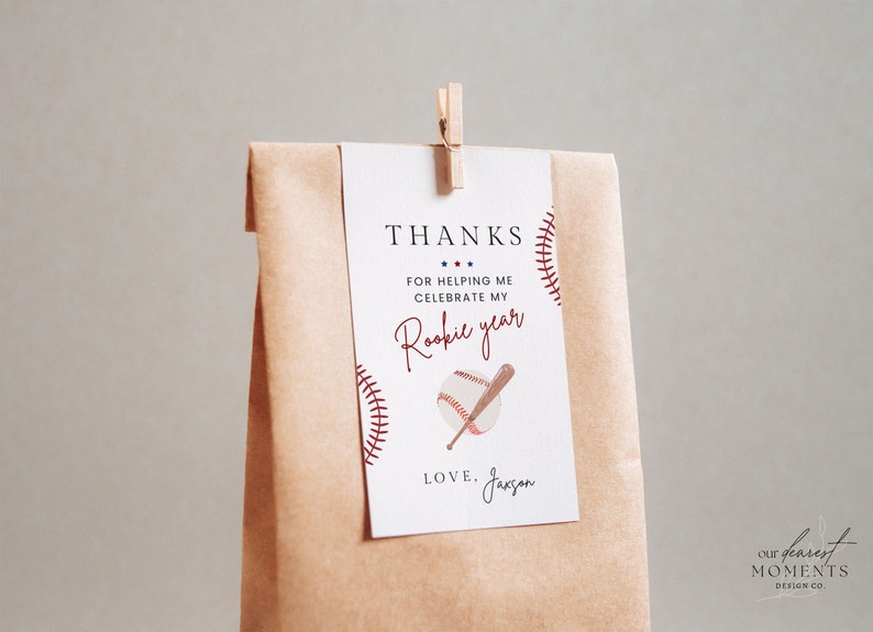 May include: A white thank you card with red and blue accents. The card features a baseball and bat graphic and the text "THANKS FOR HELPING ME CELEBRATE MY Rookie year LOVE. Jaxsan".