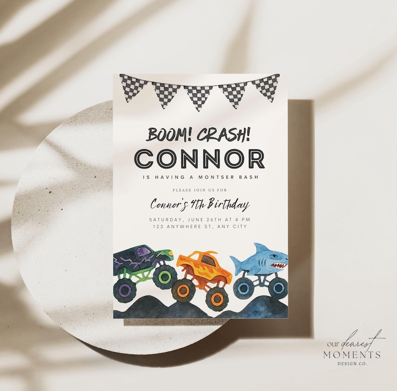 May include: A birthday invitation with the text "BOOM! CRASH! CONNOR" and "Connor's 4th Birthday". The invitation features illustrations of three monster trucks in purple, orange, and blue, with a checkered flag banner at the top.