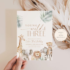 May include: A printable invitation for a third birthday party with a jungle theme. The invitation features a giraffe, elephant, zebra, lion, and leopard with the text "Young Wild & Three" in gold lettering.