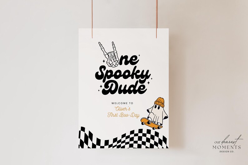 May include: A white sign with black text that reads "One Spooky Dude" and "Welcome to Oliver's First Boo-Day". A cartoon ghost wearing a beanie is skateboarding over a black and white checkered pattern.