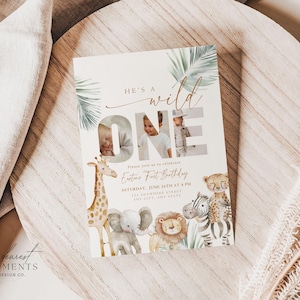 May include: A cream-colored invitation card with the text "He's a Wild One" and a photo of a child. The card features illustrations of a giraffe, elephant, lion, zebra, and cheetah. The invitation includes the child's name, date, time, and location.