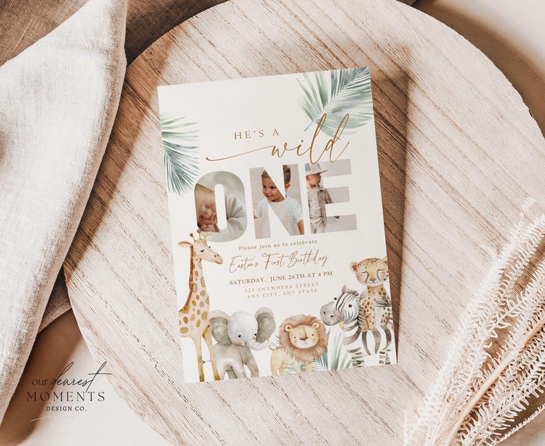 May include: A cream-colored invitation card with the text "He's a Wild One" and a photo of a child. The card features illustrations of a giraffe, elephant, lion, zebra, and cheetah. The invitation includes the child's name, date, time, and location.