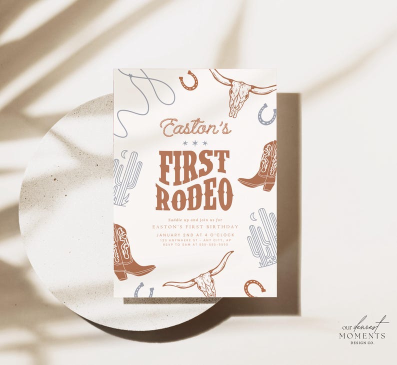 May include: A white invitation with brown and blue illustrations of a cowboy boot, cactus, horseshoe, and a skull with horns. The text on the invitation reads "Easton's First Rodeo" and includes details for a birthday party.