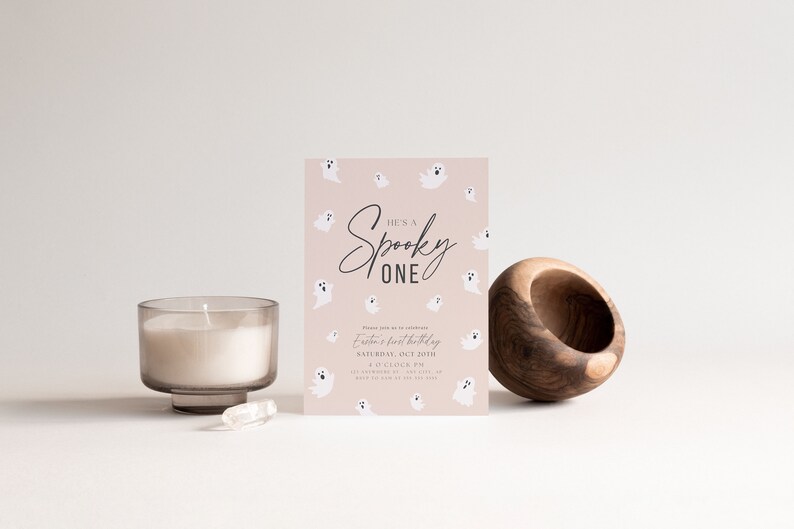 May include: A pink and white Halloween-themed invitation with the text "He's a Spooky One" and a ghost pattern. The invitation is for a first birthday party.