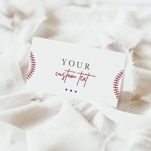 May include: A white card with red and blue baseball stitching on the sides. The card has the text "YOUR custom text" in black.