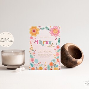 May include: A pink and white birthday invitation with colorful flowers and the text "You're invited to a Three-esta Oliver's third birthday Saturday, Dec 20th 121 Anywhere Street Any City, Any State RSVP to Taran"