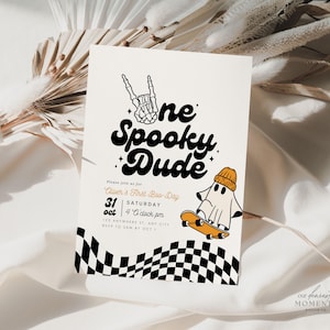 May include: A rectangular invitation card featuring the text One Spooky Dude, a skeleton hand sign, and a ghost wearing an orange beanie on a skateboard. The bottom border has a black and white checkerboard pattern, with event details printed in black.