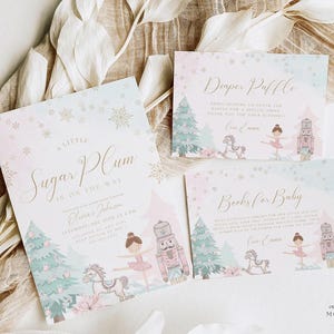 May include: Baby shower invitations and cards with a winter theme. The invitations feature a ballerina, nutcracker, rocking horse, and Christmas trees in pastel colors. The text reads "A Little Sugar Plum is on the Way."