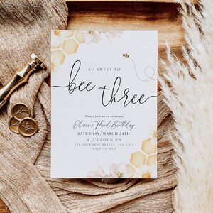 May include: A bee-themed birthday invitation featuring a yellow and white honeycomb pattern, pink flowers, and a bee flying above the text "So Sweet to Bee Three". The invitation includes the text "Olivia's Third Birthday" and details for the event, including the date, time, and location.