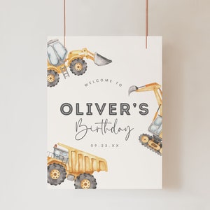 May include: A white printable sign with a yellow excavator, a yellow dump truck, and the text "Welcome to Oliver's Birthday 09.23.XX".