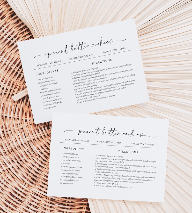May include: Two printable recipe cards for peanut butter cookies. The cards are white with black text and include the ingredients and directions for making the cookies. The cards are on a woven wicker background.