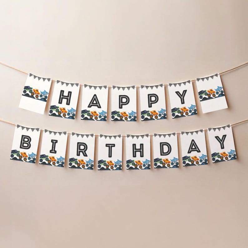 May include: A birthday banner spelling out "HAPPY BIRTHDAY" in black capital letters on white flags. Each flag has a black and white triangle border and a row of colourful monster truck illustrations along the bottom.