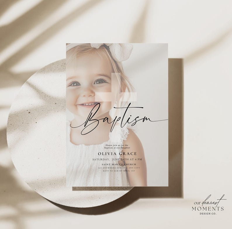 May include: Baptism invitation featuring a smiling child in a white dress. The invitation includes the word "Baptism" in elegant script, along with event details: Olivia Grace, Saturday, June 26th at 4 PM, and Saint Mary's Church. The design has a soft, neutral color palette.