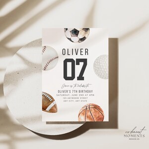 May include: A rectangular birthday invitation card featuring watercolour illustrations of a football, baseball, golf ball, American football, and basketball. The text reads: OLIVER 07, Join us to celebrate, OLIVER'S 7TH BIRTHDAY, SATURDAY, JUNE 2ND AT 4PM, 123 ANYWHERE STREET, ANY CITY, ANY STATE.