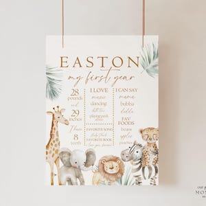 May include: A printable first birthday milestone chart for a baby boy named Easton. The chart features a jungle theme with illustrations of a giraffe, elephant, lion, and zebra. It includes details like weight, height, favorite foods, and things the baby can say.