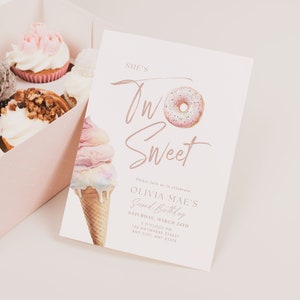 May include: A pale pink birthday invitation with the words "She's Two Sweet" and a donut and ice cream cone illustration. The invitation is for Olivia Mae's second birthday, with the date, time, and address. A box of cupcakes is visible in the background.