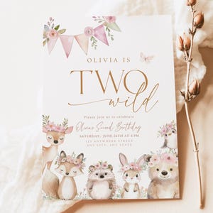 May include: A birthday invitation with the text "Olivia is Two Wild." The invitation features watercolor illustrations of woodland animals, including a deer, fox, hedgehog, rabbit, and bear, all adorned with floral crowns.