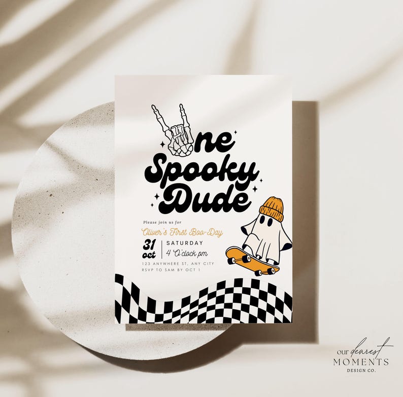 May include: A rectangular invitation card featuring the text One Spooky Dude, a skeleton hand making a peace sign, and a ghost wearing an orange beanie on a skateboard. The bottom border has a black and white checkered pattern with wavy lines.