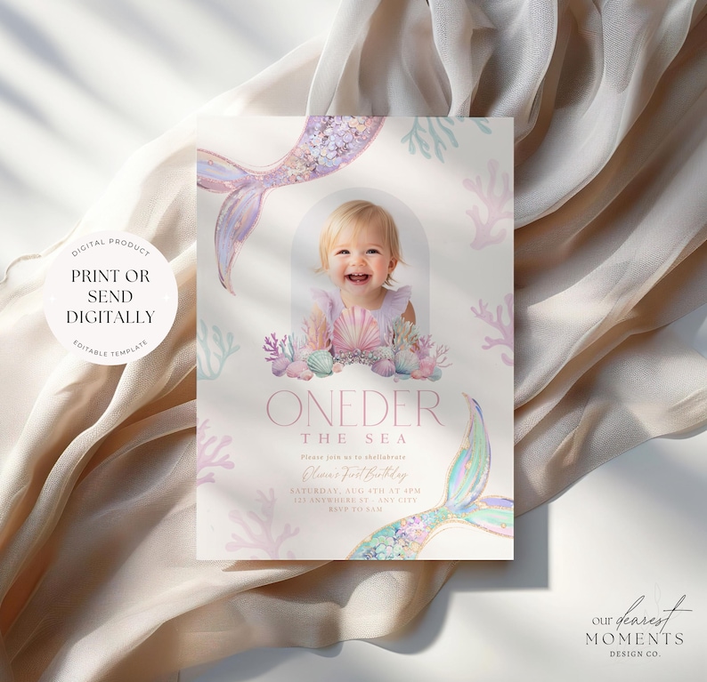 May include: A pink and blue mermaid-themed first birthday party invitation with a photo of a baby girl in a seashell crown. The invitation says "One-der the Sea" and includes the date, time, and location of the party.