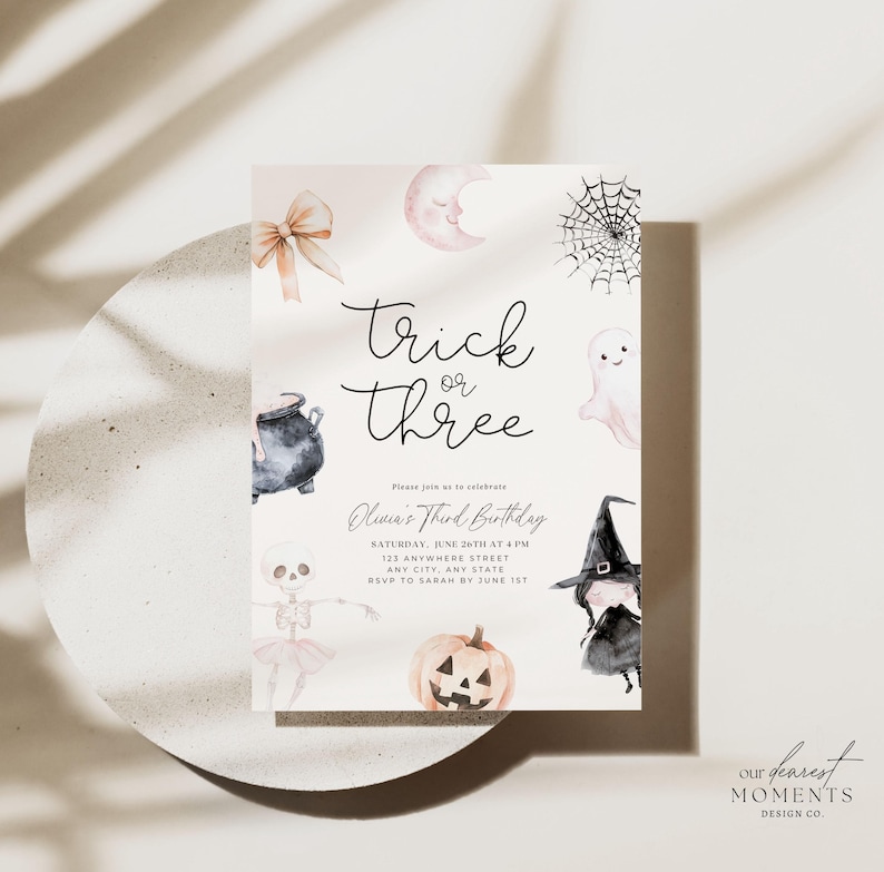 May include: A Halloween-themed birthday invitation featuring a watercolour illustration of a witch, a ghost, a cauldron, a pumpkin, a skeleton, a spider web, and a crescent moon. The text reads "Trick or Three" and "Olivia's Third Birthday".