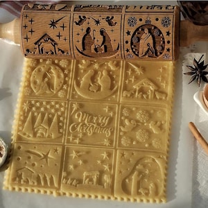May include: A wooden rolling pin with a Christmas theme. The rolling pin has a variety of designs carved into it, including stars, angels, and a nativity scene. The rolling pin is being used to roll out dough for cookies. The dough is imprinted with the designs from the rolling pin.