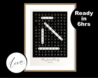 May include: Framed word search art print with a black background and white letters. The words "ALEX" and "JACQUES" are highlighted. The print is in a wooden frame and includes the text "The Jones Family - Est. 2018".