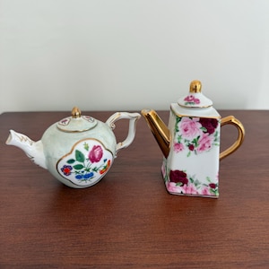 Vintage miniature 2 teapot with a floral design.