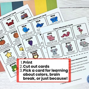 May include: Educational color movement cards with illustrations of objects and animals in various colors. The cards include instructions for physical activities. Text on the cards reads: "Colors Movement Cards". A pair of blue scissors is also visible.