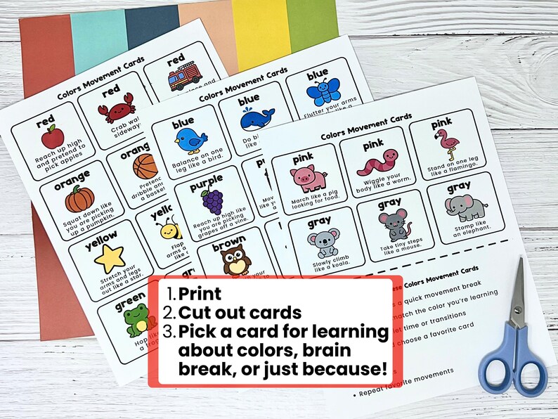 May include: Educational color movement cards with illustrations of objects and animals in various colors. The cards include instructions for physical activities. Text on the cards reads: "Colors Movement Cards". A pair of blue scissors is also visible.