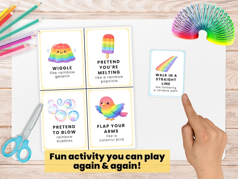 May include: Four illustrated activity cards with instructions, featuring a rainbow jelly, ice lolly, bubbles, and bird. Text reads "Fun activity you can play again & again!" A rainbow slinky and scissors are also visible.