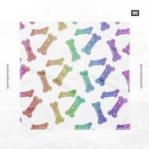 May include: A white background with a repeating pattern of rainbow colored dog bone shapes.