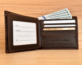 May include: Brown leather wallet with multiple card slots and a billfold. The wallet has a clear ID window with spaces for name, address, and phone number. The wallet is engraved with the text "Engineer • Pilot • EMR • All American".
