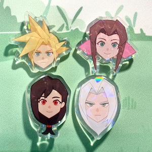 May include: Four clear acrylic charms featuring stylized character portraits. The characters have distinct hairstyles and facial features, with colors including blonde, brown, and silver. Each charm has a holographic, iridescent effect.