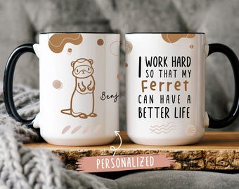 May include: White ceramic coffee mug with a black handle. The mug has a brown and white abstract design on one side and the text "I work hard so that my ferret can have a better life" on the other side. The mug is personalized with the name "Benj".